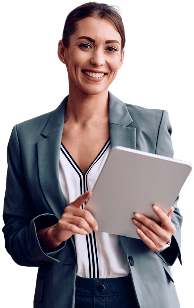A woman in a blazer is smiling and holding a tablet, standing against a plain background.